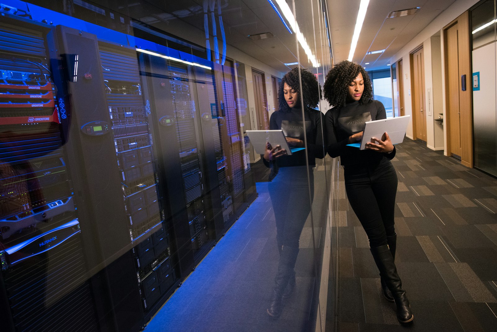 Engineer working beside cloud servers in a data centre